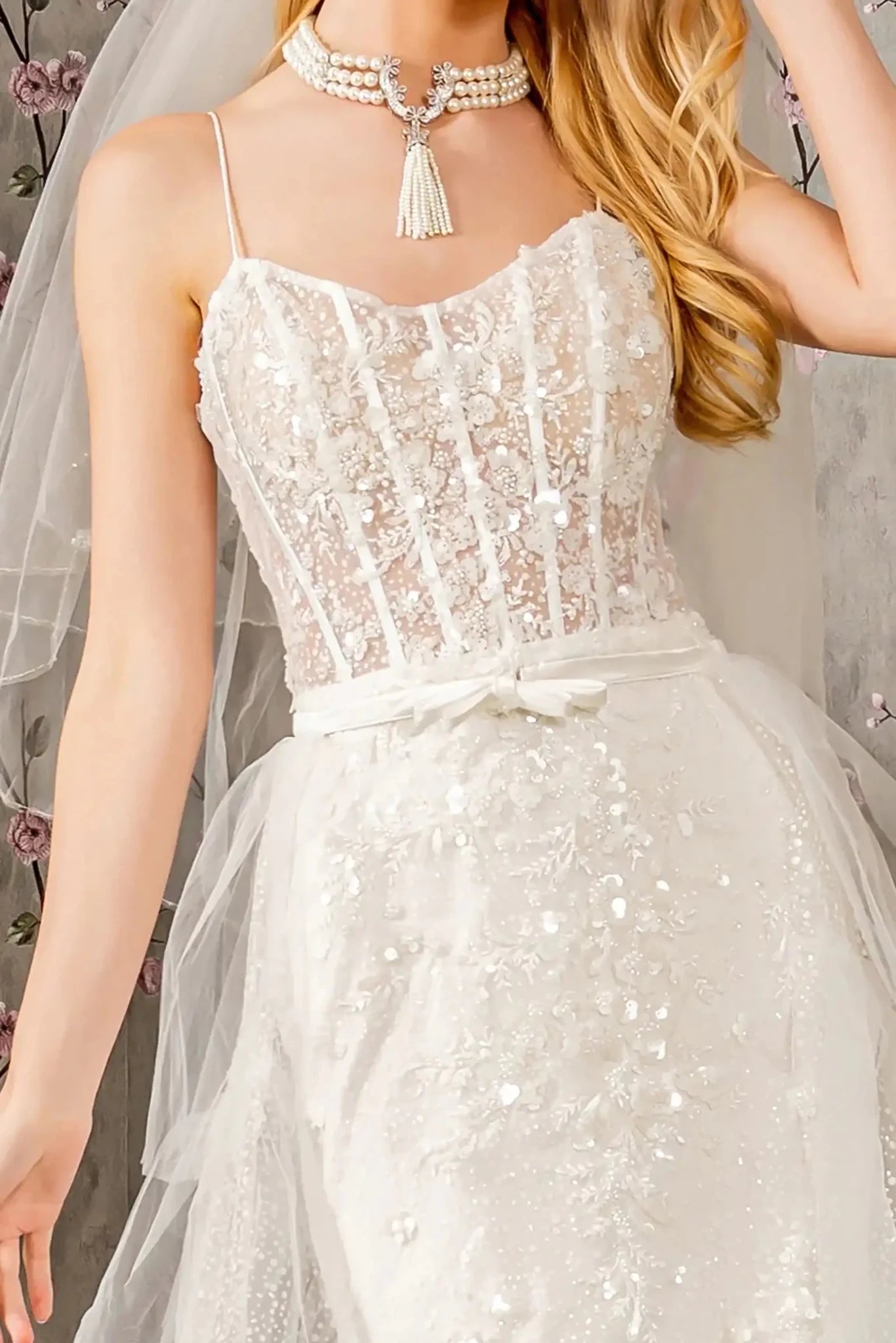 Front close-up upper view highlighting the shimmering texture of the beaded embroidery and the fine glitter detail across the curved scoop neckline and thin spaghetti straps.