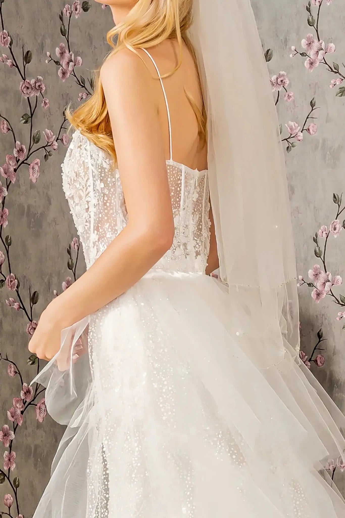Back close-up upper view focusing on the sheer open back design and the discreet central zipper closure framed by intricate floral beadwork.