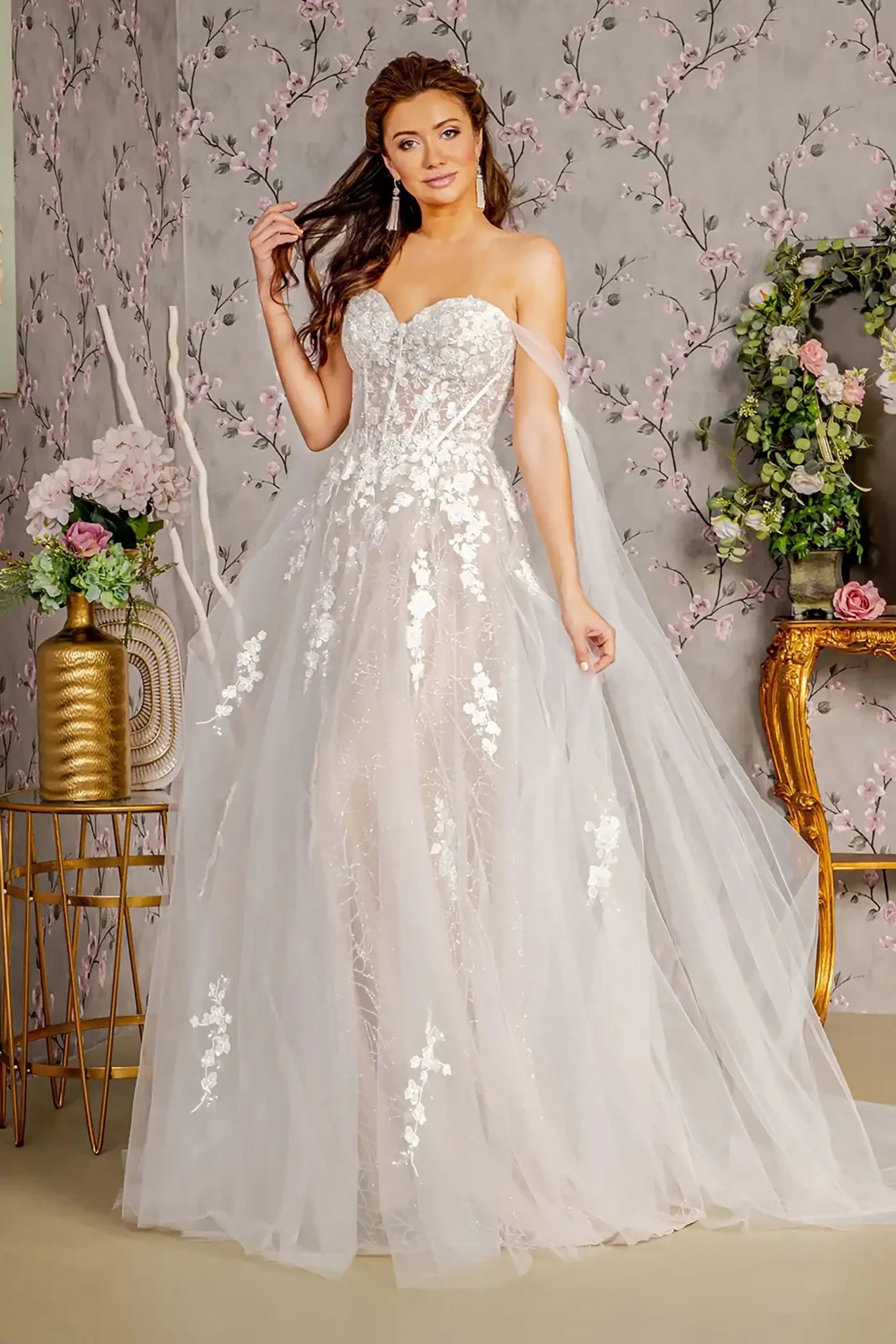 Front full-length view of an ivory mermaid wedding dress featuring a scoop neckline, delicate spaghetti straps, and a dramatic long mesh cape.