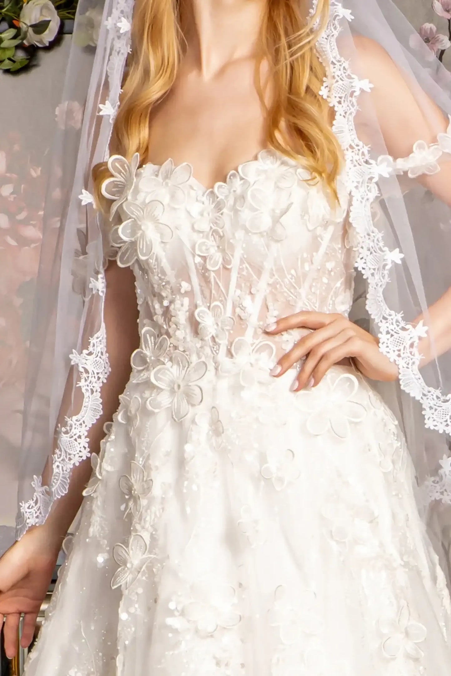 Front close-up upper view of Ivory A-line wedding dress with sweetheart neckline, off-shoulder mesh bodice, 3-D floral embroidery, beads, sequins, glitter, and sheer corset lace-up back with side drapes