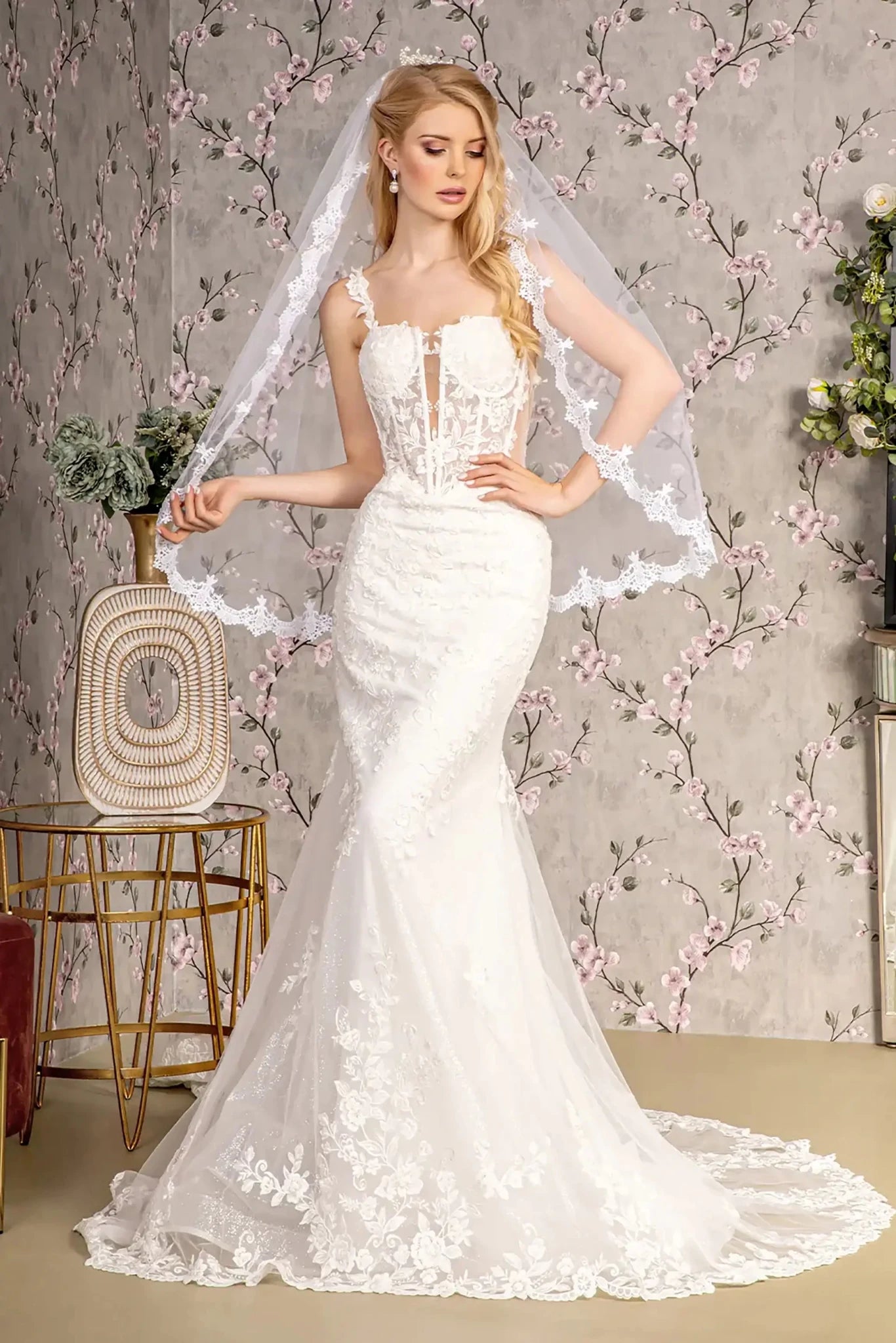 Front full-length view of an ivory mermaid wedding dress featuring a straight-across neckline, delicate beaded spaghetti straps, and a sheer mesh bodice.
