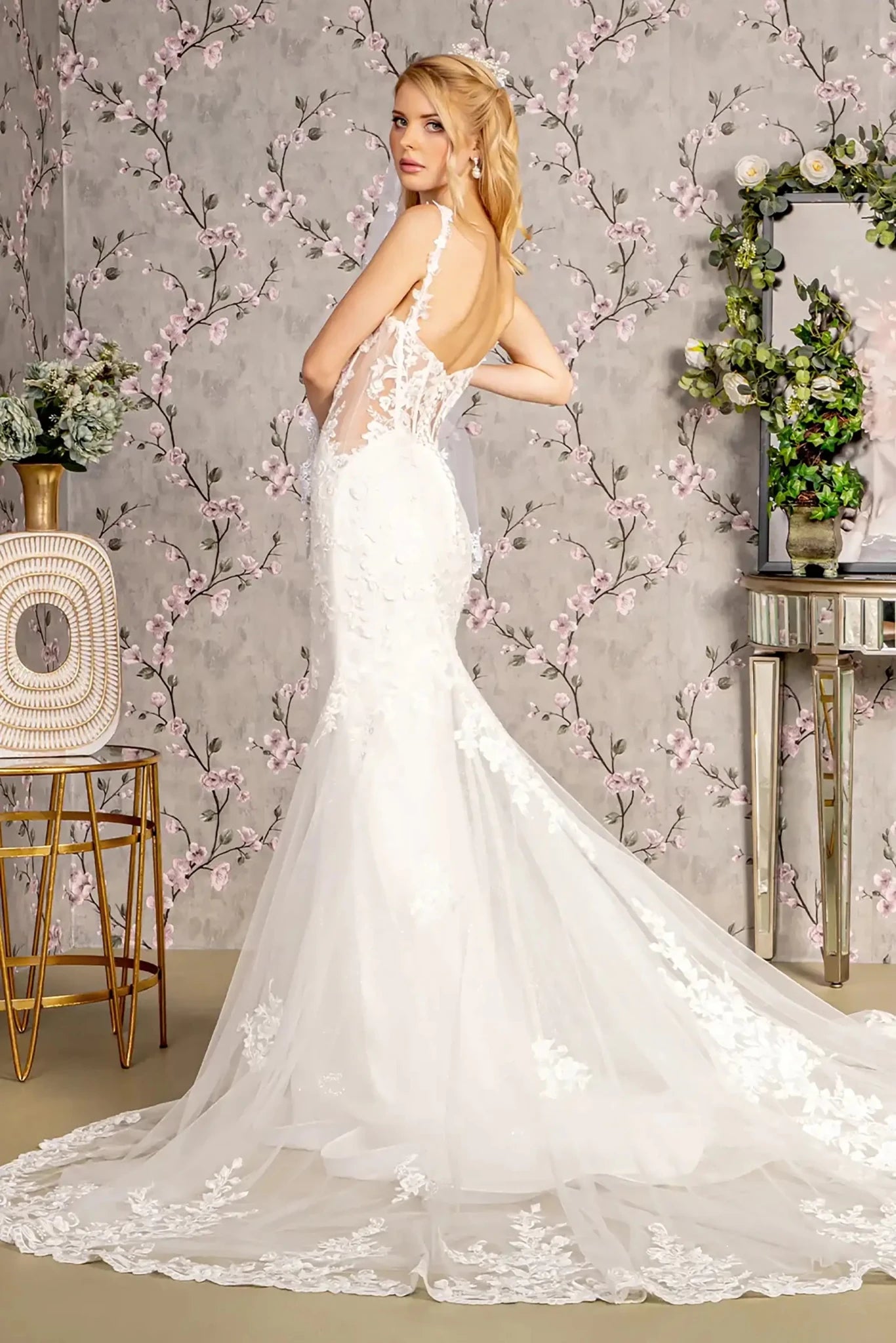 Back full-length view showcasing the fitted mermaid silhouette and the sparkling extension of the glitter-infused train adorned with sequined lace.