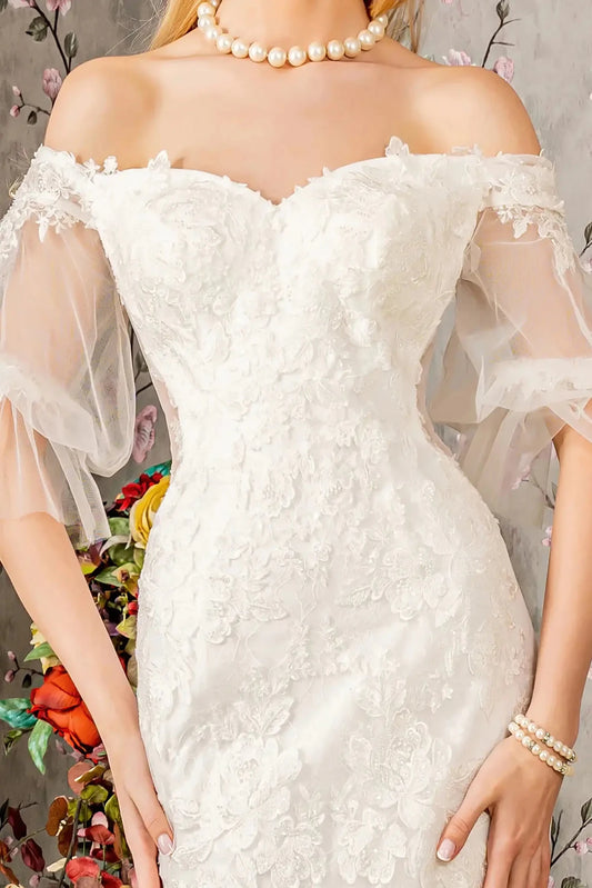 Front close-up upper view highlighting the intricate floral embroidery and delicate beadwork decorating the sweetheart bodice and the soft texture of the translucent short sleeves.