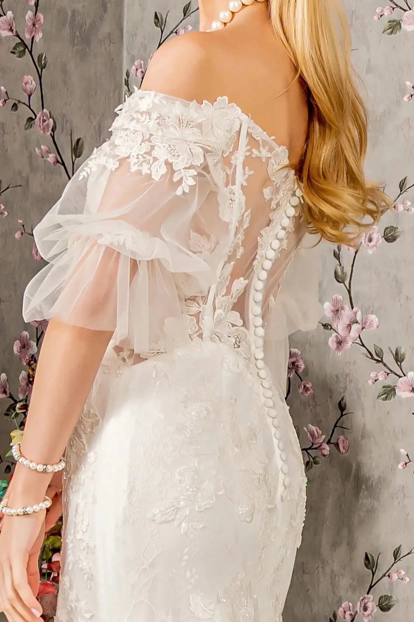 Back close-up upper view focusing on the elegant sheer back construction, showcasing the row of traditional fabric-covered buttons and the hidden central zipper closure.