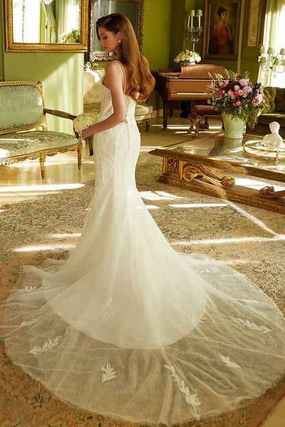 Back full-length view showcasing the dramatic flared skirt and the shimmering sequined lace underlayer that extends into a beautiful bridal train.
