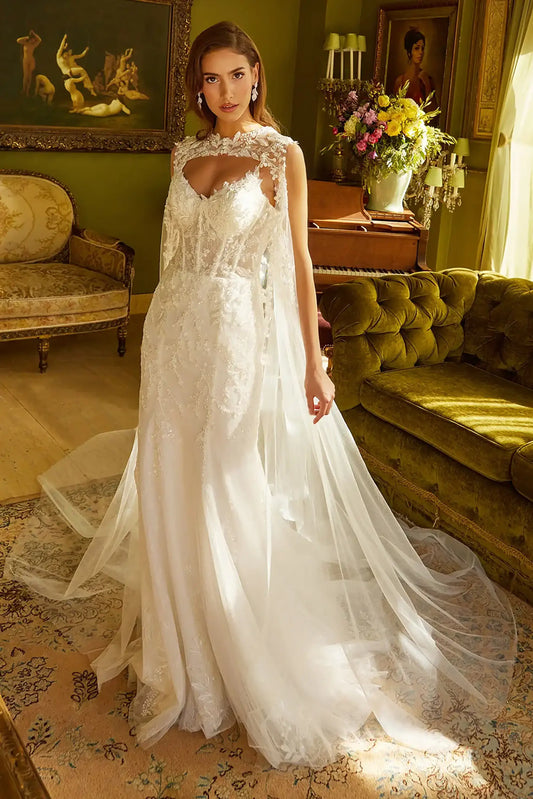 Front full-length view of an off-white trumpet wedding dress featuring a V-neck corset bodice, beaded embroidery, and a matching cape train.