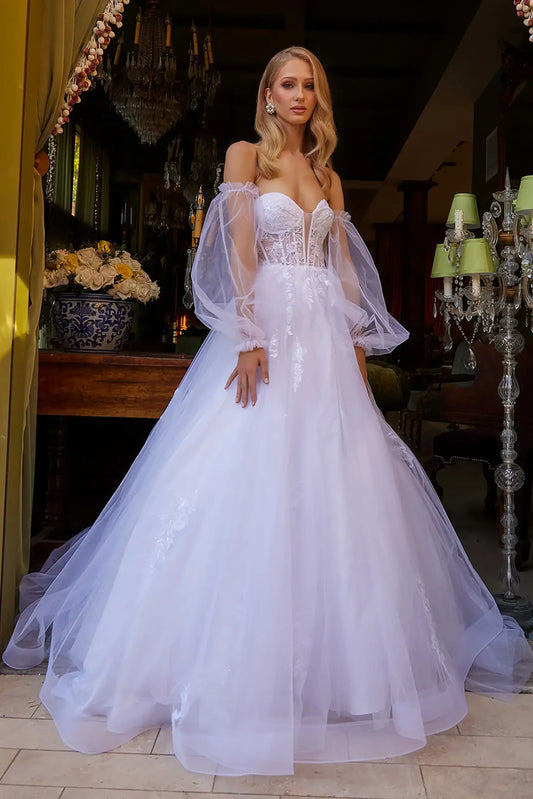 Front full-length view of a white A-line wedding dress featuring an illusion sweetheart neckline, a beaded embroidered corset bodice, and a floor-length skirt with a train.