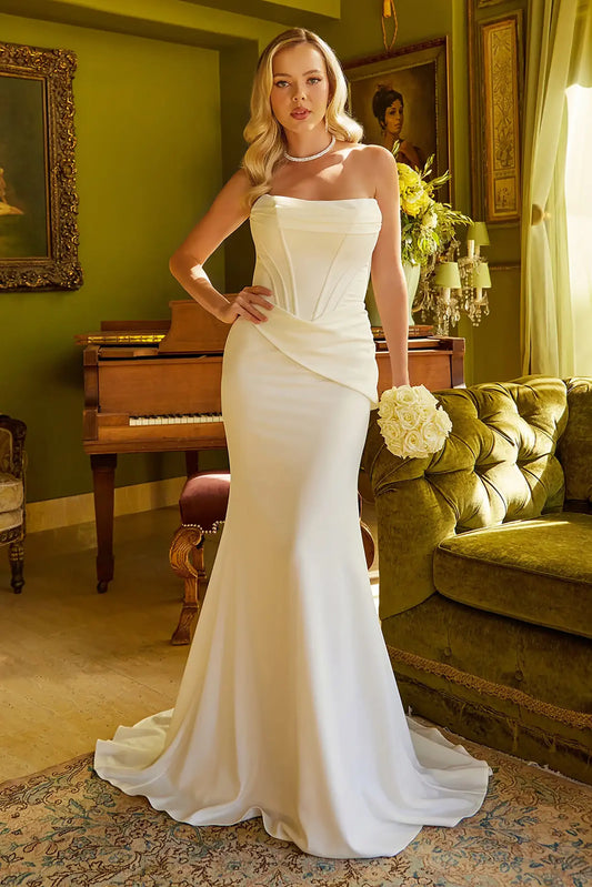 Front full-length view of an ivory fitted wedding dress featuring a sleek mermaid or trumpet silhouette with a strapless corset bodice and a structured boat neckline.