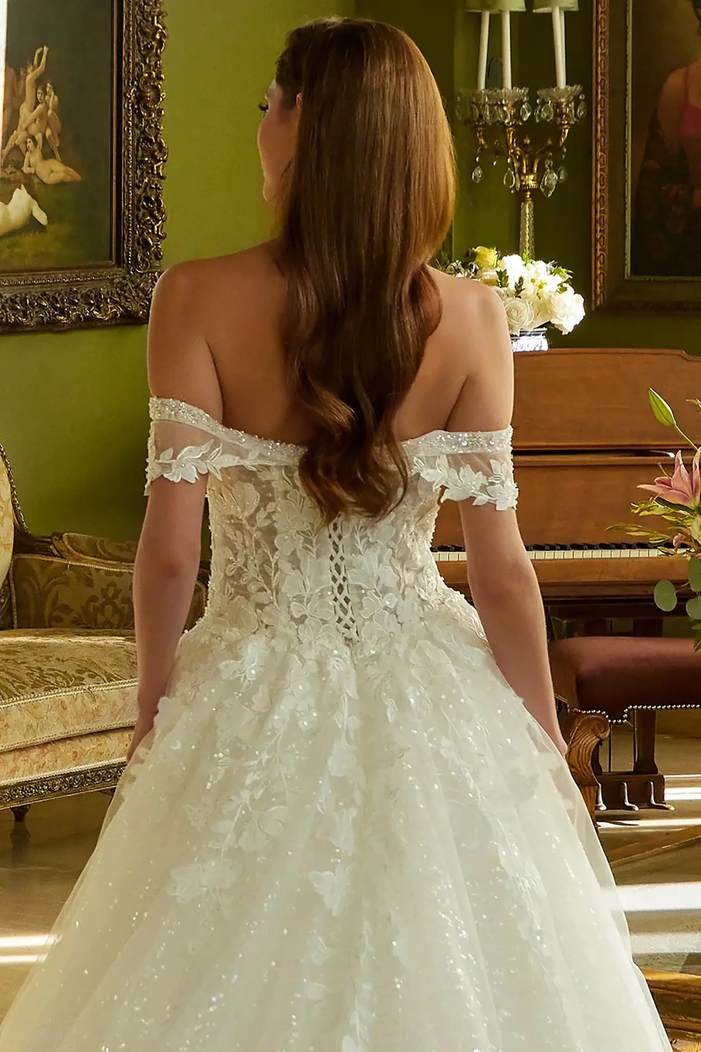 Back close-up upper view focusing on the traditional lace-up corset back closure and the continuation of the beaded embroidery across the rear bodice.