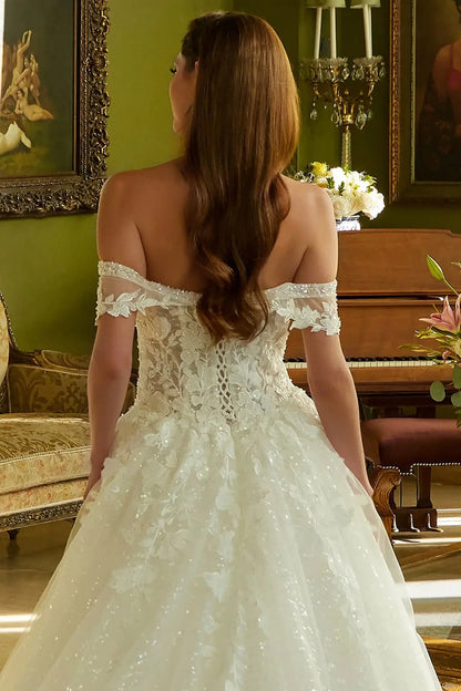 Back close-up upper view focusing on the traditional lace-up corset back closure and the continuation of the beaded embroidery across the rear bodice.