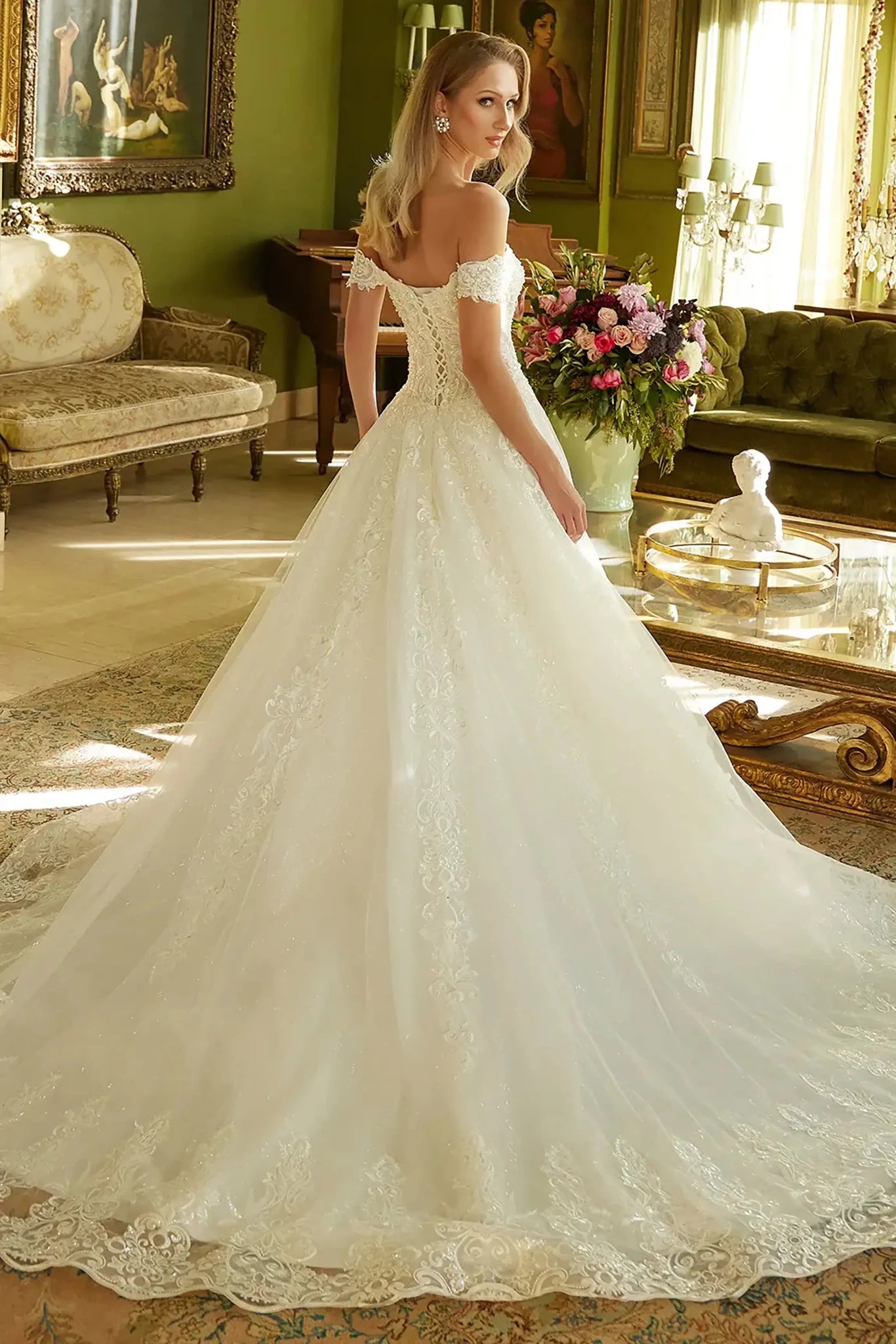 Back full-length view showcasing the dramatic sweep of the sequined mesh train and the elegant flared silhouette of the bridal gown.