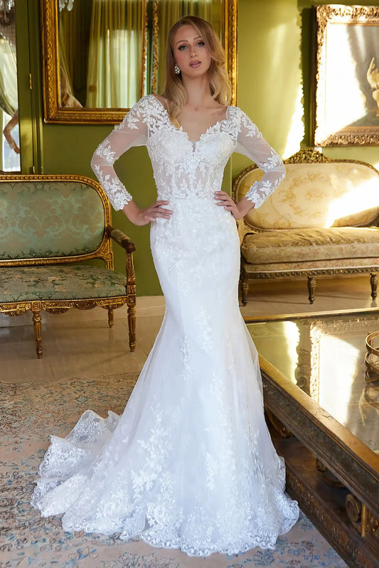Front full-length view of an off-white mermaid wedding dress featuring a V-neck corset bodice, long sheer mesh sleeves, and a matching choker mesh cape.