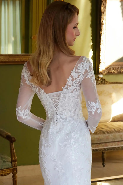 Back close-up upper view focusing on the classic lace-up back closure and the sheer texture of the mesh sleeves and cape transition.