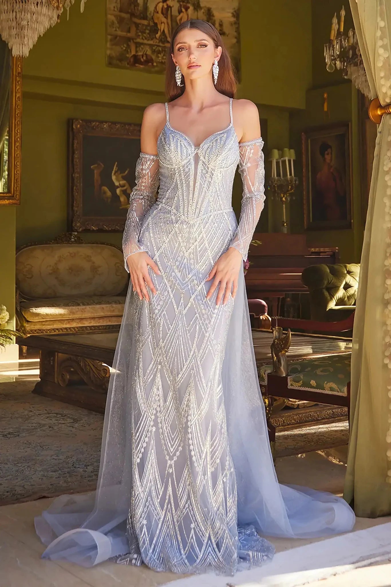 Front full-length view of a  Smoky blue jeweled fitted prom dress with detachable sleeves and tulle overskirt
