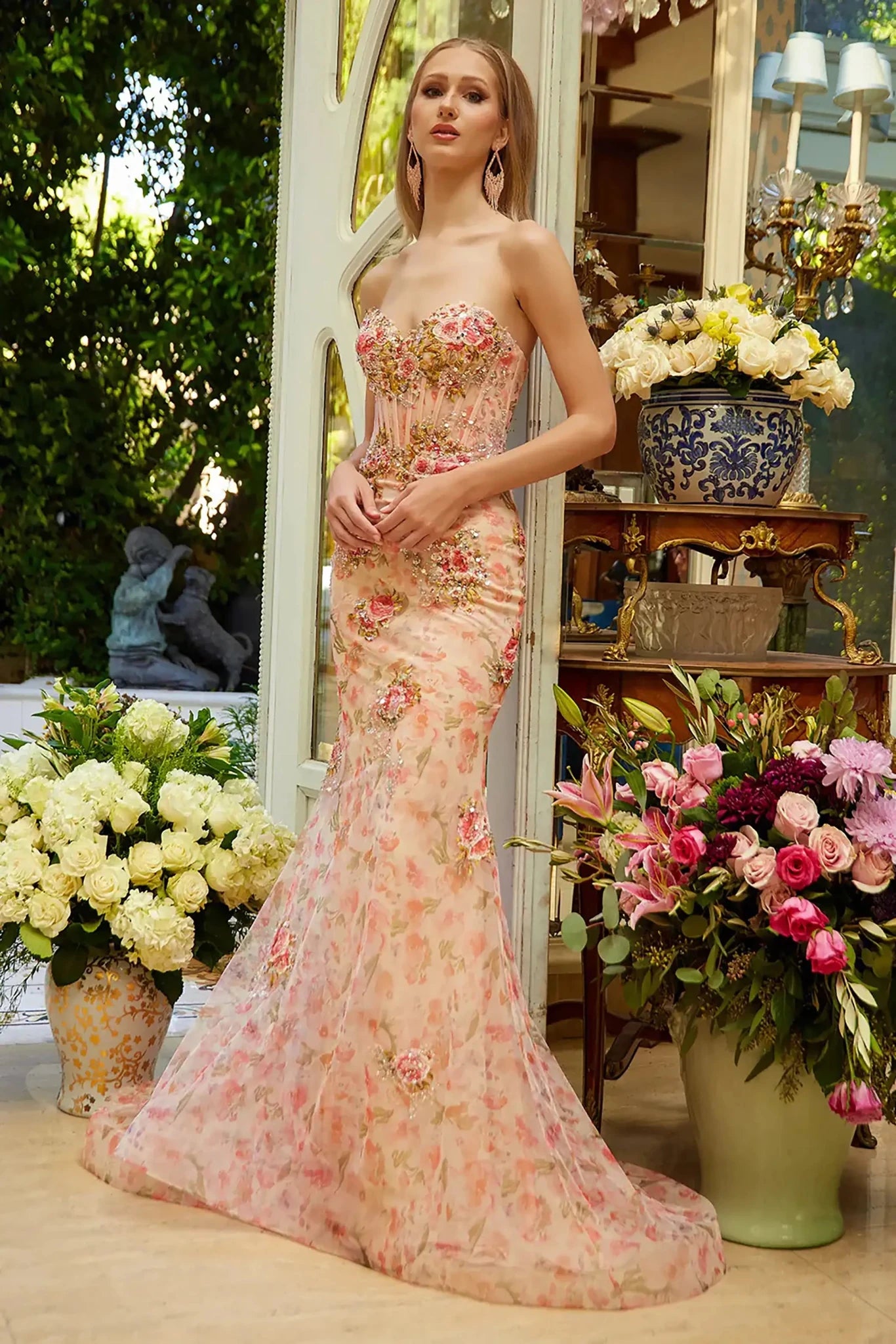 Front full-length view of a  Peach strapless floral applique prom dress with sweetheart corset bodice