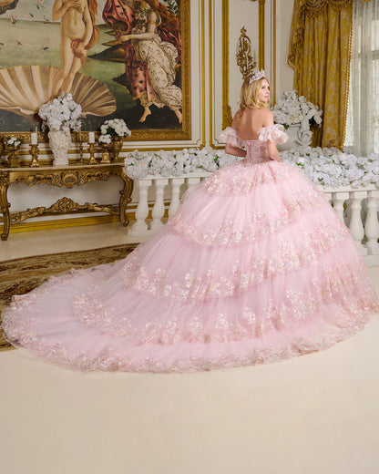 Woman in a pink ball gown standing in an opulent room with decorative walls and furniture.