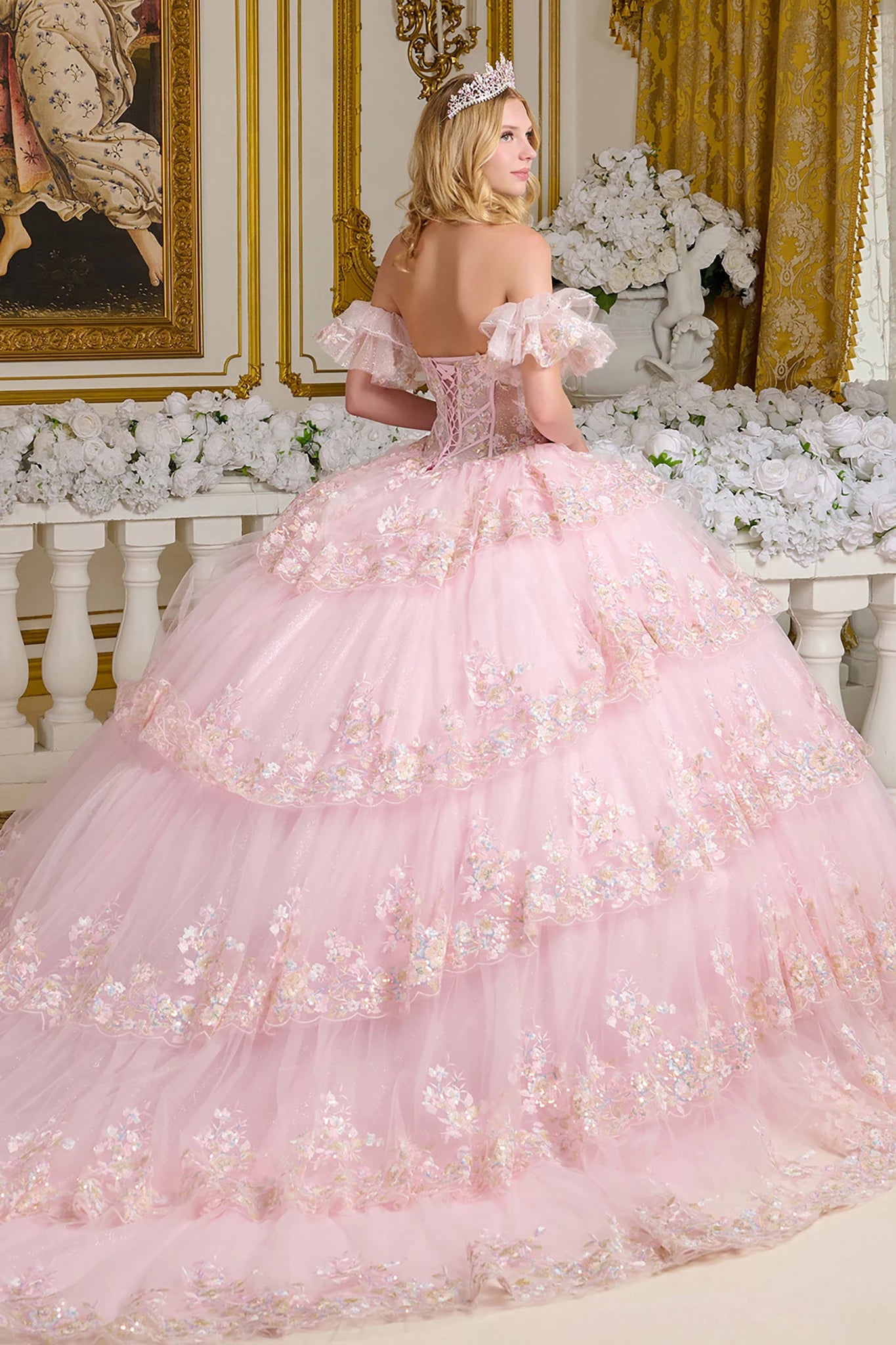 Pink quince ball gown with floral details in a decorated room