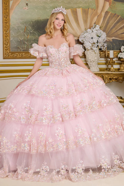 Woman in a pink floral quince dress with a tiara in an elegant interior setting