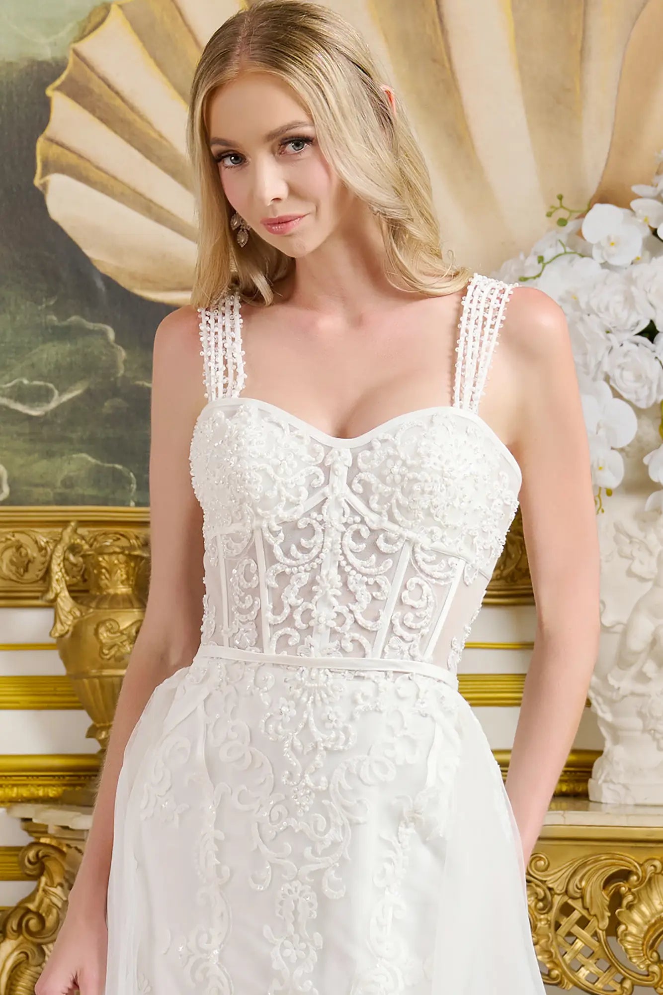 Woman wearing a white lace dress in an ornate interior setting