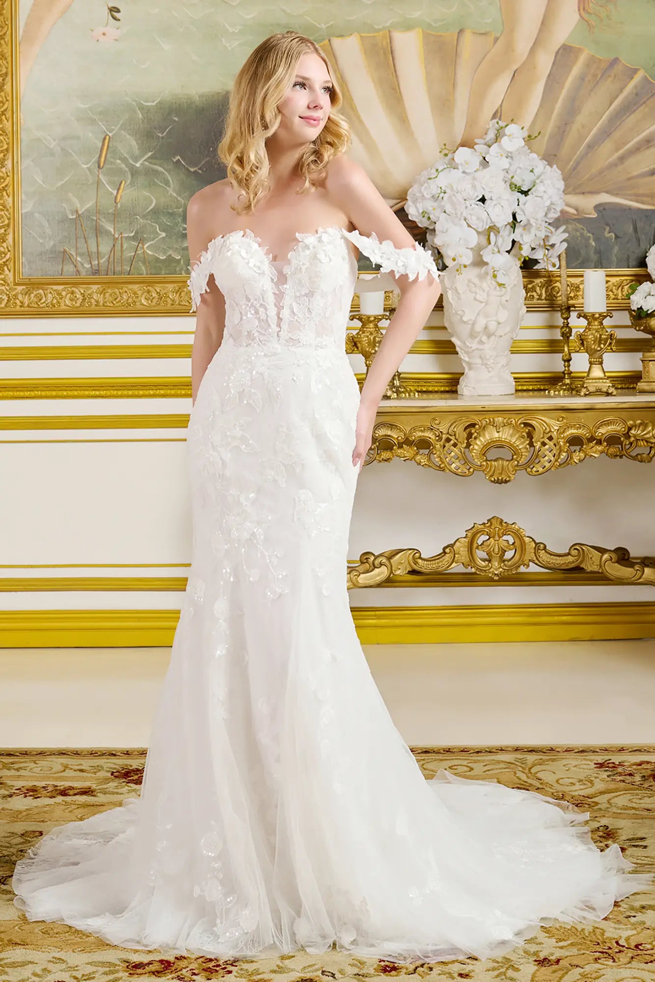 Woman in a white wedding dress standing in an ornate room with gold accents.