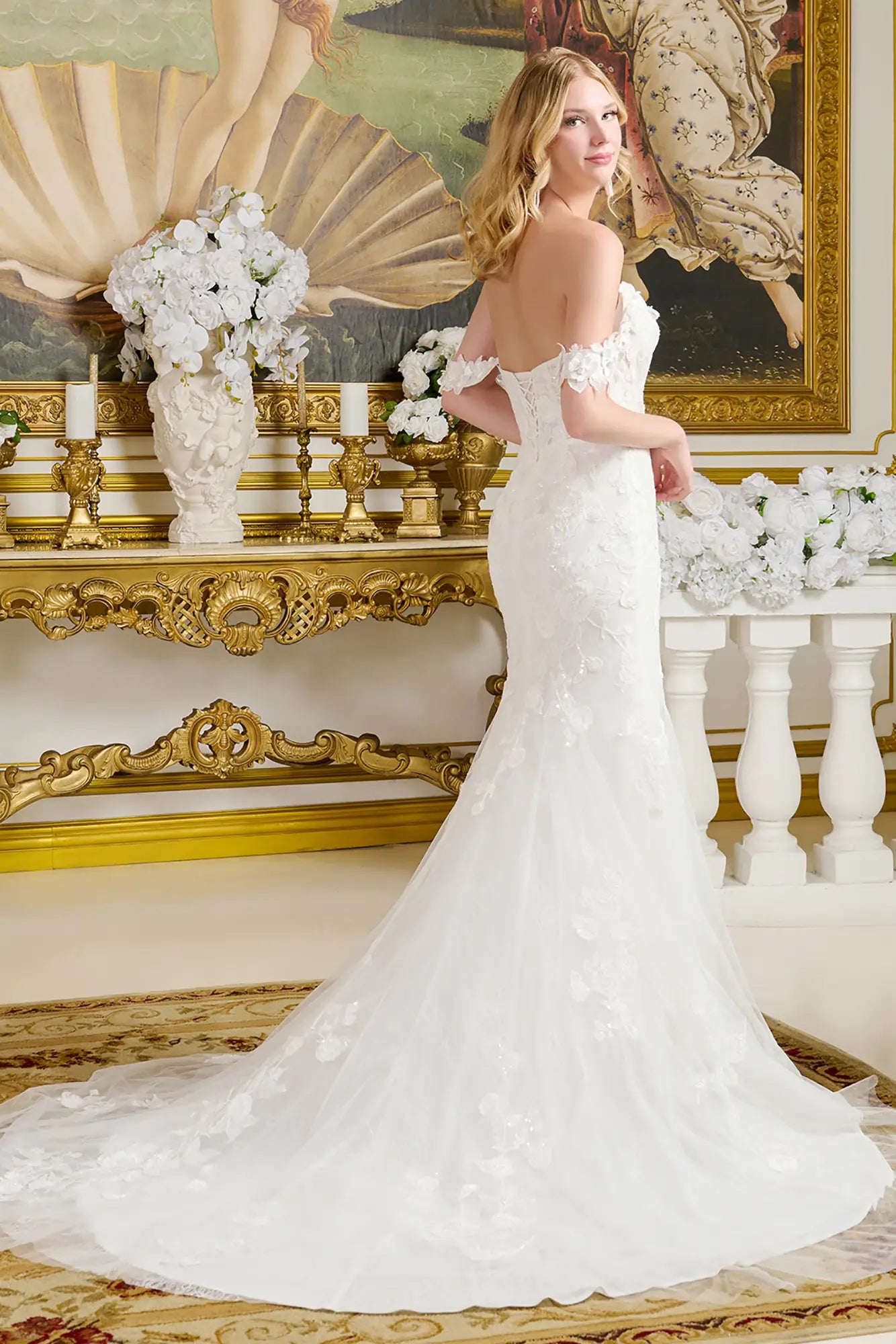 Woman in a white wedding dress standing in an ornate room with decorative elements.