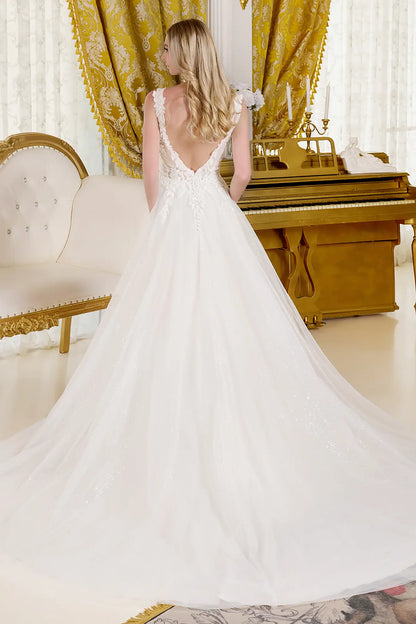 Beautiful back view of the woman wearing a wedding gown in an opulent room settings.