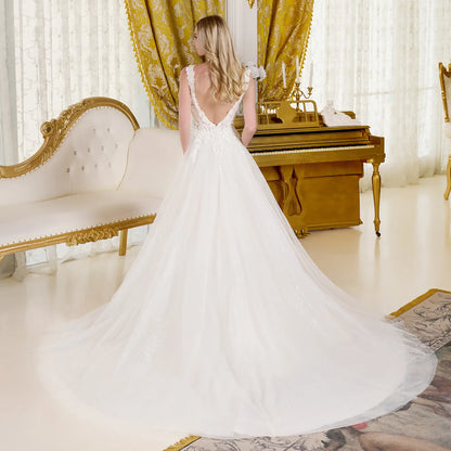 Beautiful back view of a woman wearing a wedding dress in a full terrain dress