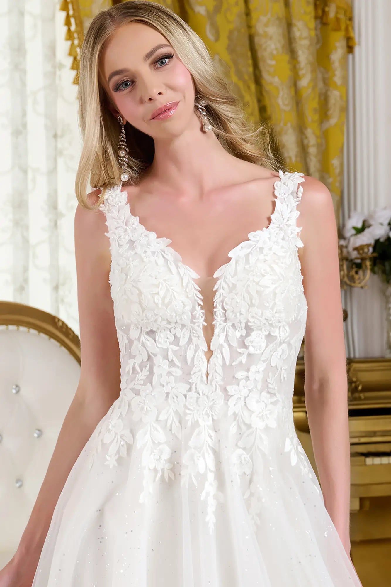 Woman wearing a wedding dress with a fitted V-neck bodice.