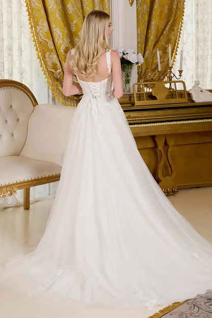 Woman showing the back view of her wedding gown in an opulent room