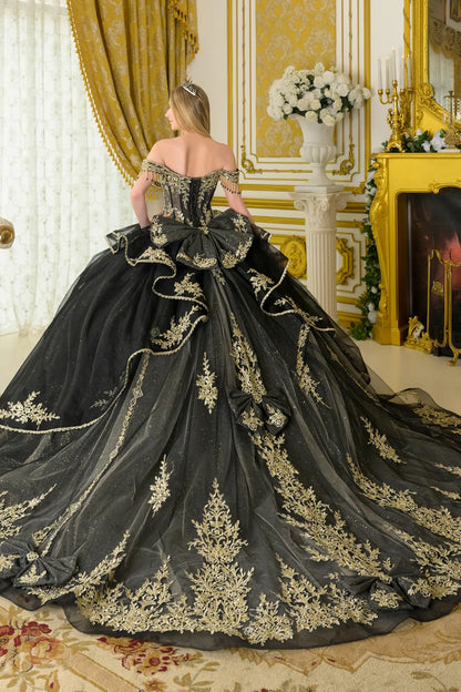 Back view of black quinceañera ball gown featuring lace-up corset back, oversized detachable bow, gold embroidery, off-the-shoulder sleeves, and voluminous glitter tulle skirt