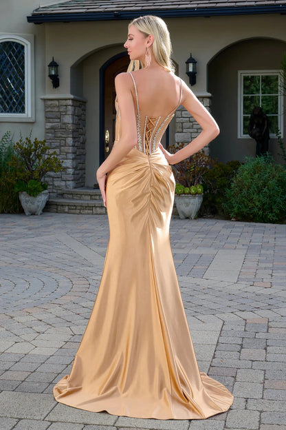Back full-length view of a mocha gold spaghetti strap fitted prom dress with sheer corset bodice and satin skirt.