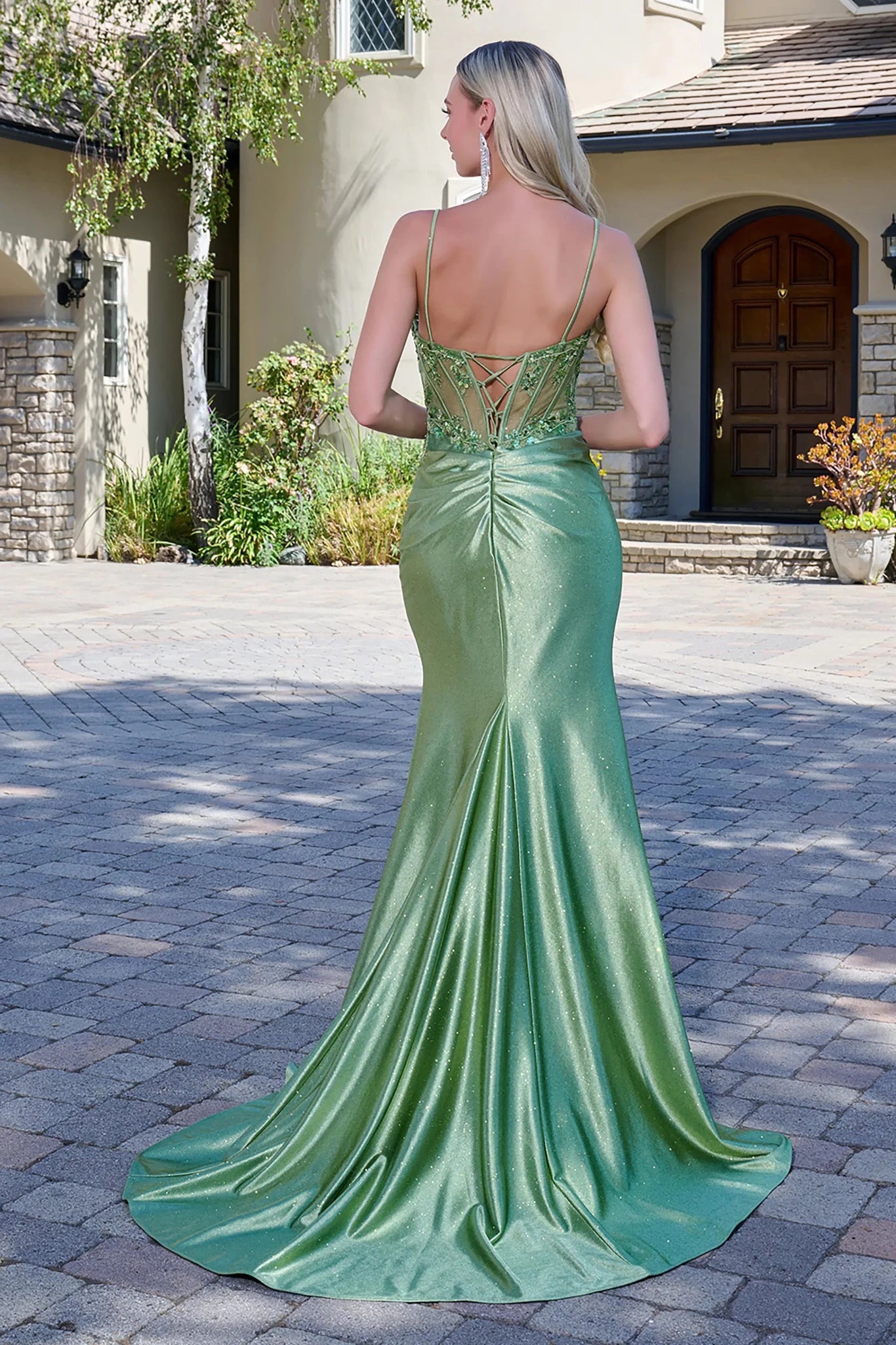 Back full-length view of a sage strapless prom dress with a sheer beaded corset bodice, boat neckline, fitted satin skirt, and a thigh-high slit in a floor-length design.