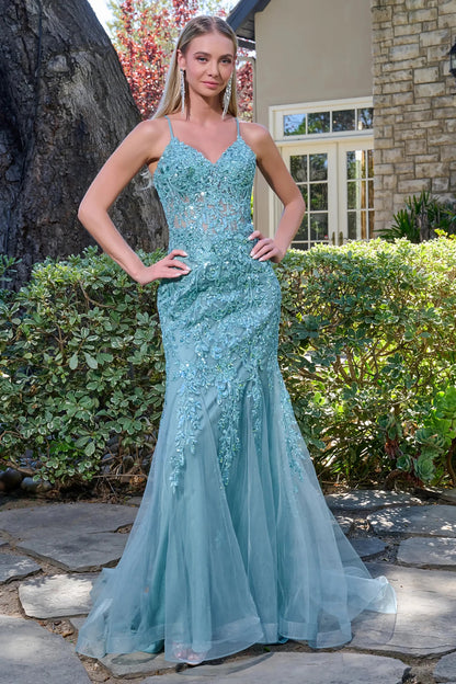 Front full-length view of a sage prom dress with a sheer V-neck corset bodice, spaghetti straps, beaded tulle fabric, and a floor-length trumpet silhouette.