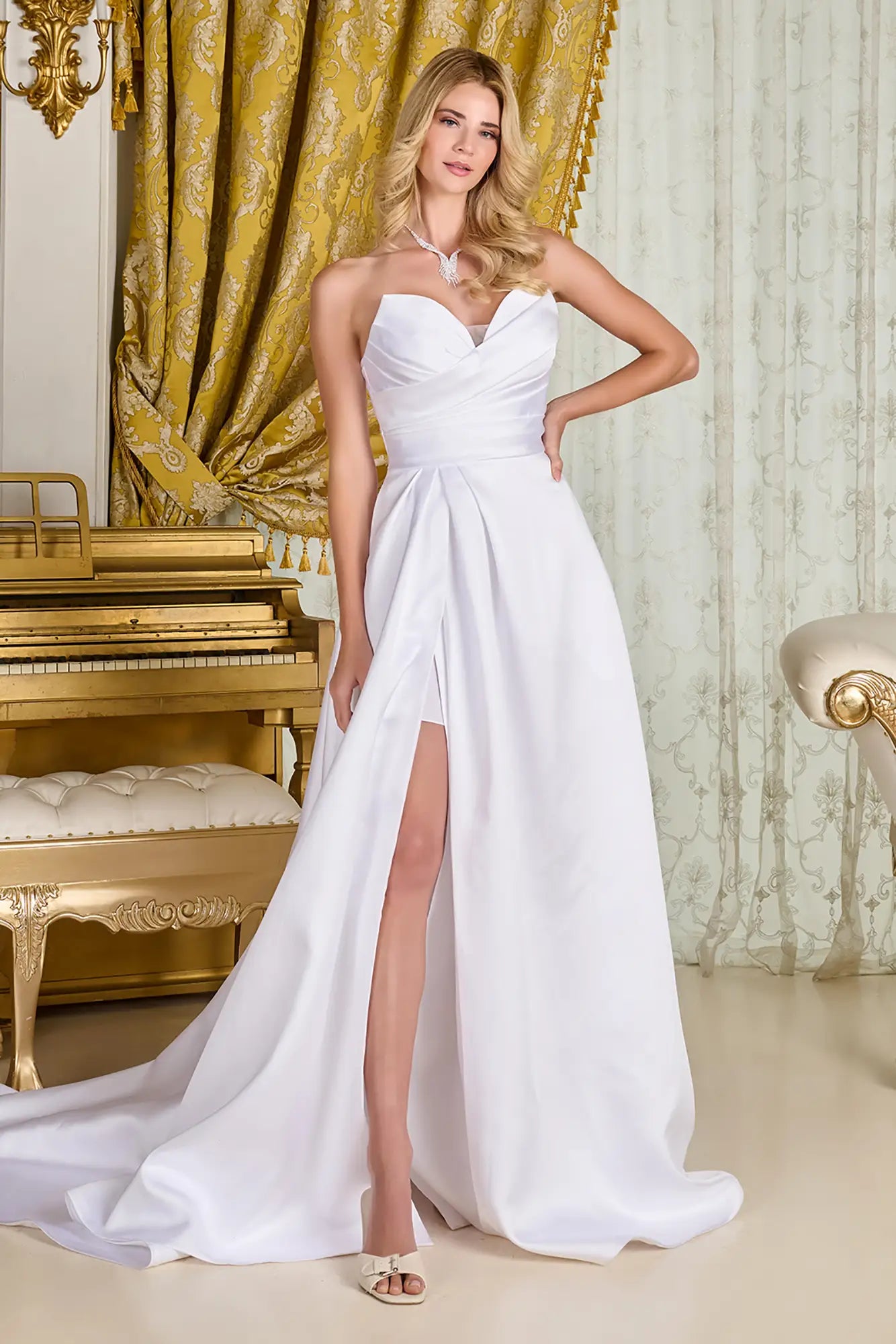 Woman in a wedding gown with strapless V-neck corset bodice, cross-over pleated overlay, and wrap-over skirt for a minimalist, elegant bridal look.