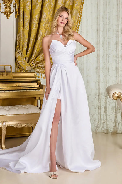 Woman in a wedding gown with strapless V-neck corset bodice, cross-over pleated overlay, and wrap-over skirt for a minimalist, elegant bridal look.