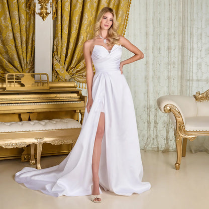 Woman in a wedding gown with strapless V-neck corset bodice, cross-over pleated overlay, and wrap-over skirt