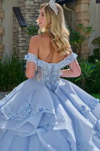 Close-up back view of light blue quinceañera ball gown with lace-up corset back, off-the-shoulder beaded straps, floral appliqués, and layered tulle overskirt