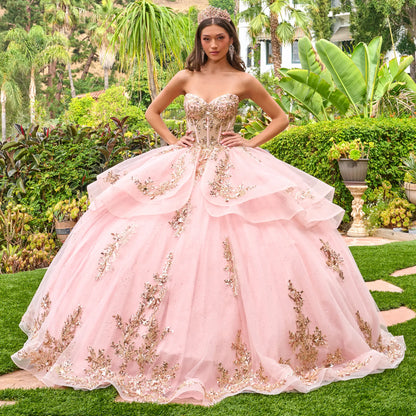 Full front view of blush pink quinceañera ball gown with structured corset, sweetheart neckline, and voluminous layered skirt with gold floral appliqués