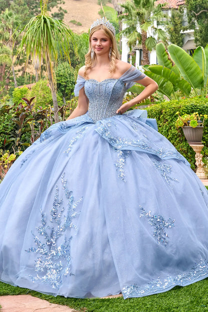 Dusty blue quinceañera ball gown with off-the-shoulder sleeves, beaded corset bodice, and embroidered tulle skirt, front view outdoors