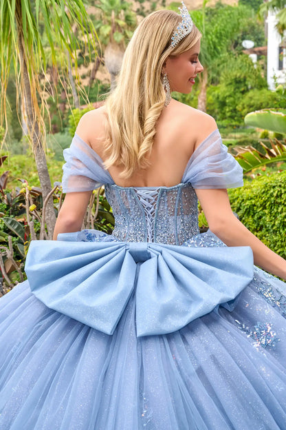 Close-up back detail of dusty blue quinceañera gown with lace-up corset, off-the-shoulder sleeves, and large bow accent
