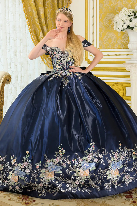 Girl wearing a navy quinceañera dress floral embroidery in an elegant room.