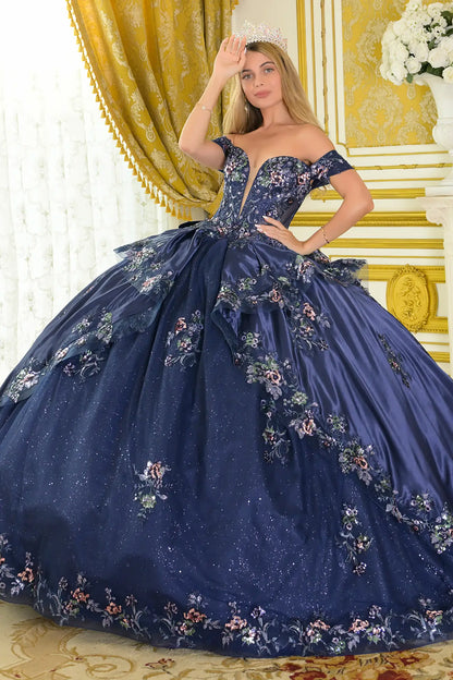 Girl wearing a navy quinceañera dress with satin-decorated bodice in a decorated room.