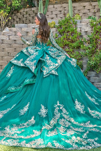 green quince ball gown with white lace details against a stone wall and cactus background