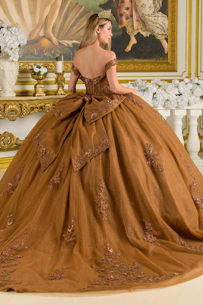 Brown ball gown with intricate detailing in a decorated room.
