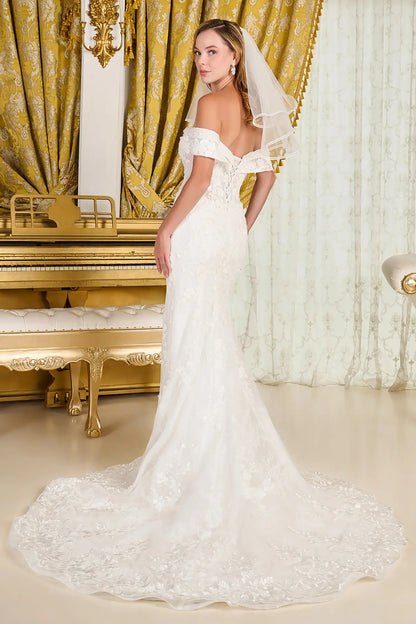 Woman in a white wedding dress standing in an opulent room with gold curtains and a piano.