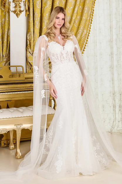 Woman in a white wedding dress standing in a room with gold curtains and a piano.