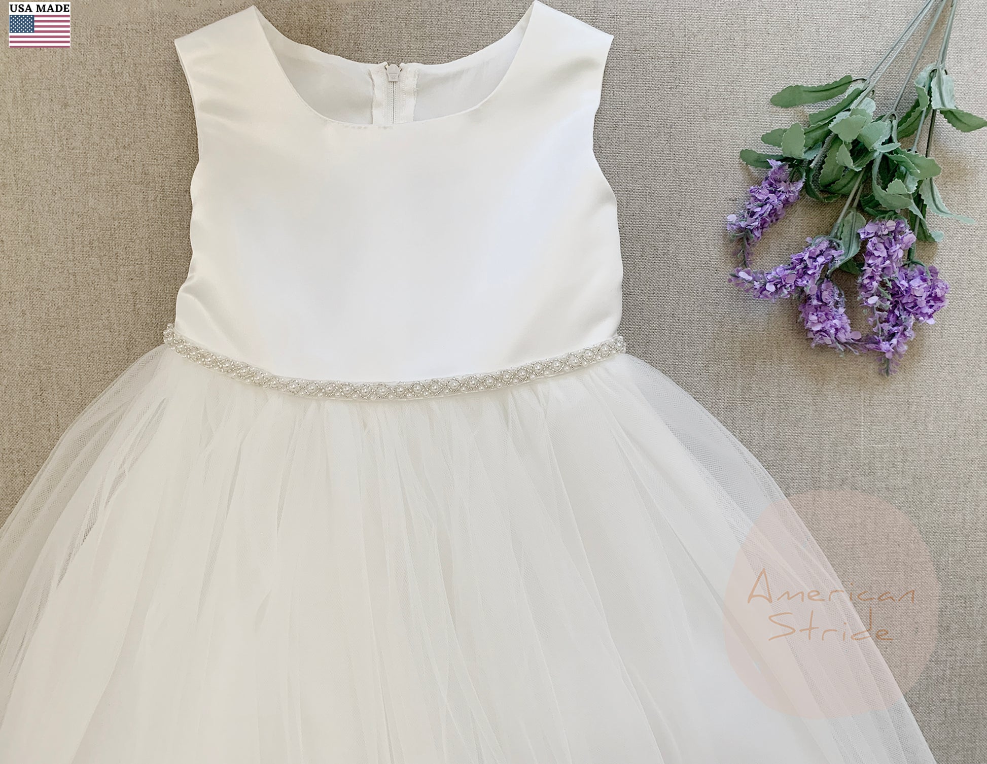 Dainty Pearl Satin and Tulle Classic Flower Girl Dress Zoomed front view with flower on right side