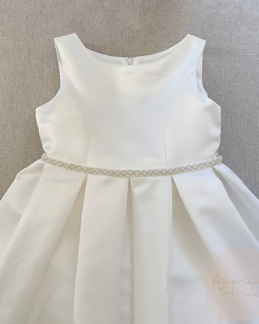 Ivory dress with a silver belt on a gray background