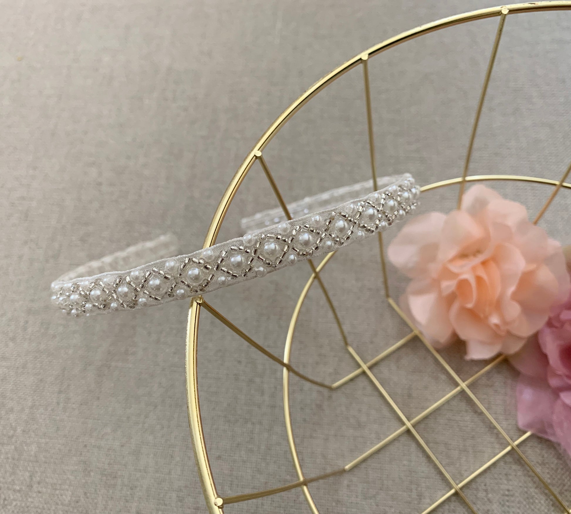 Handmade Pearl Flower Girl Headband - zoomed in view of headband on metal basket