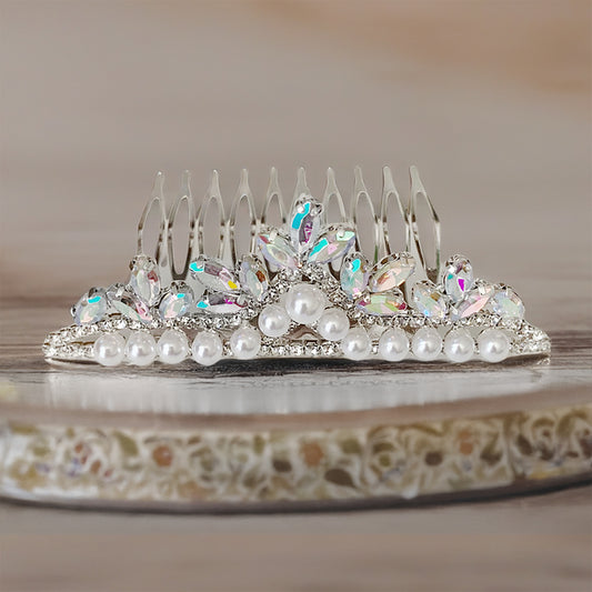 Decorative hair comb with pearls and crystals on a decorative plate